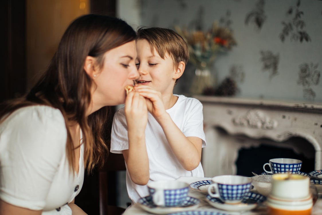 Photo of Boy Giving Food to His Mom